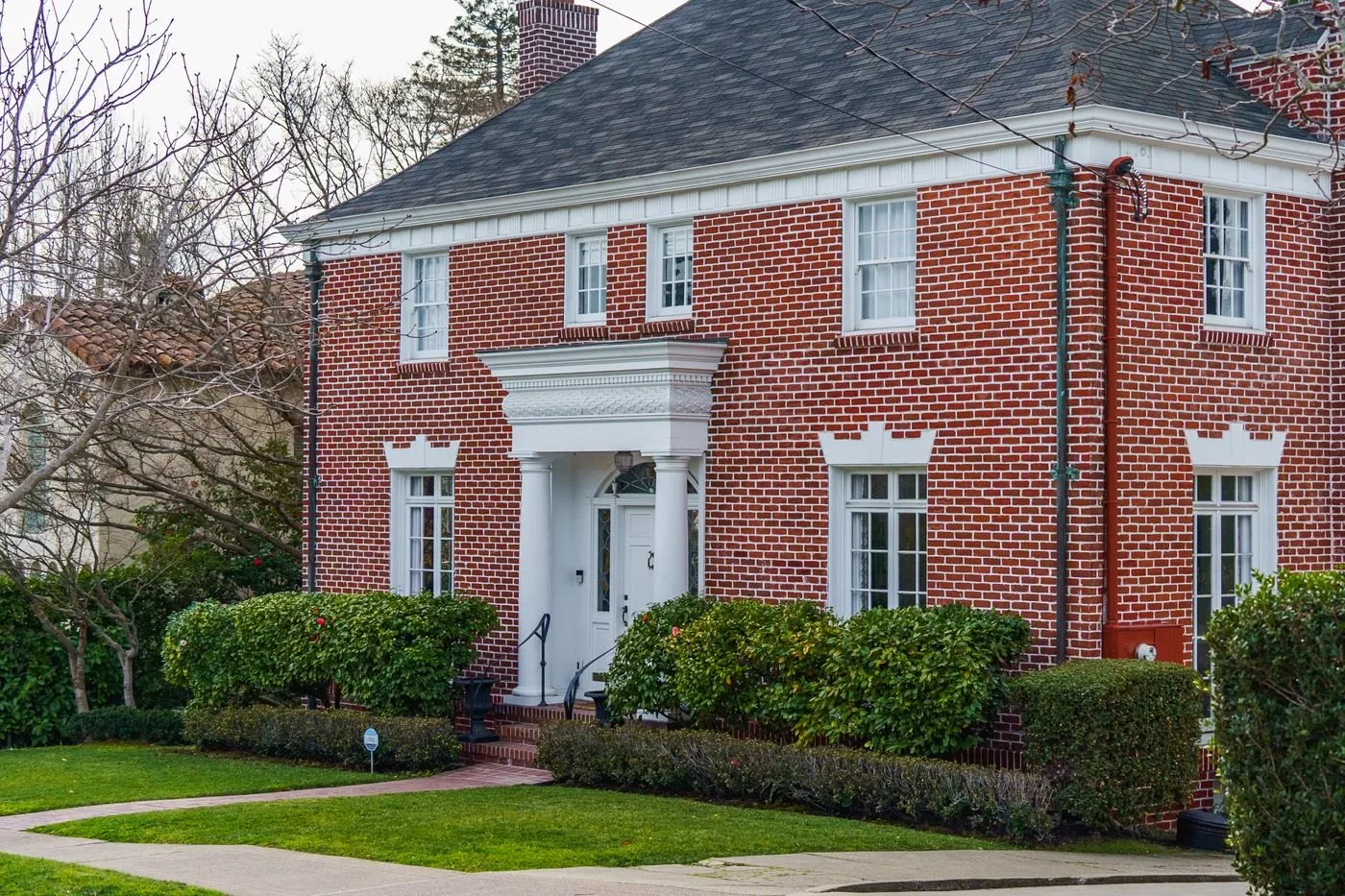 Brick home with a finished dark gray asphalt shingle roof