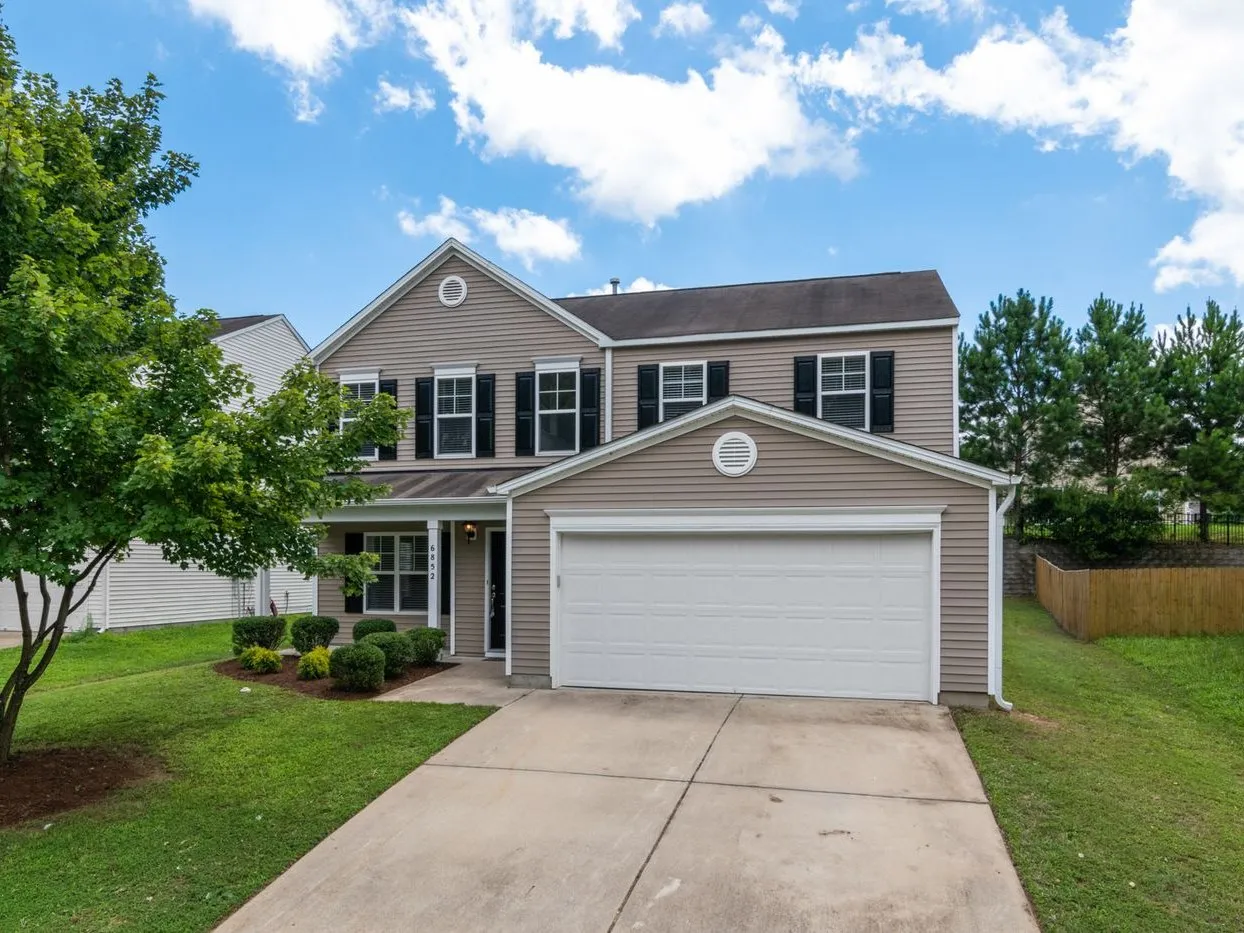 Two-story suburban home with vinyl siding and an attached garage