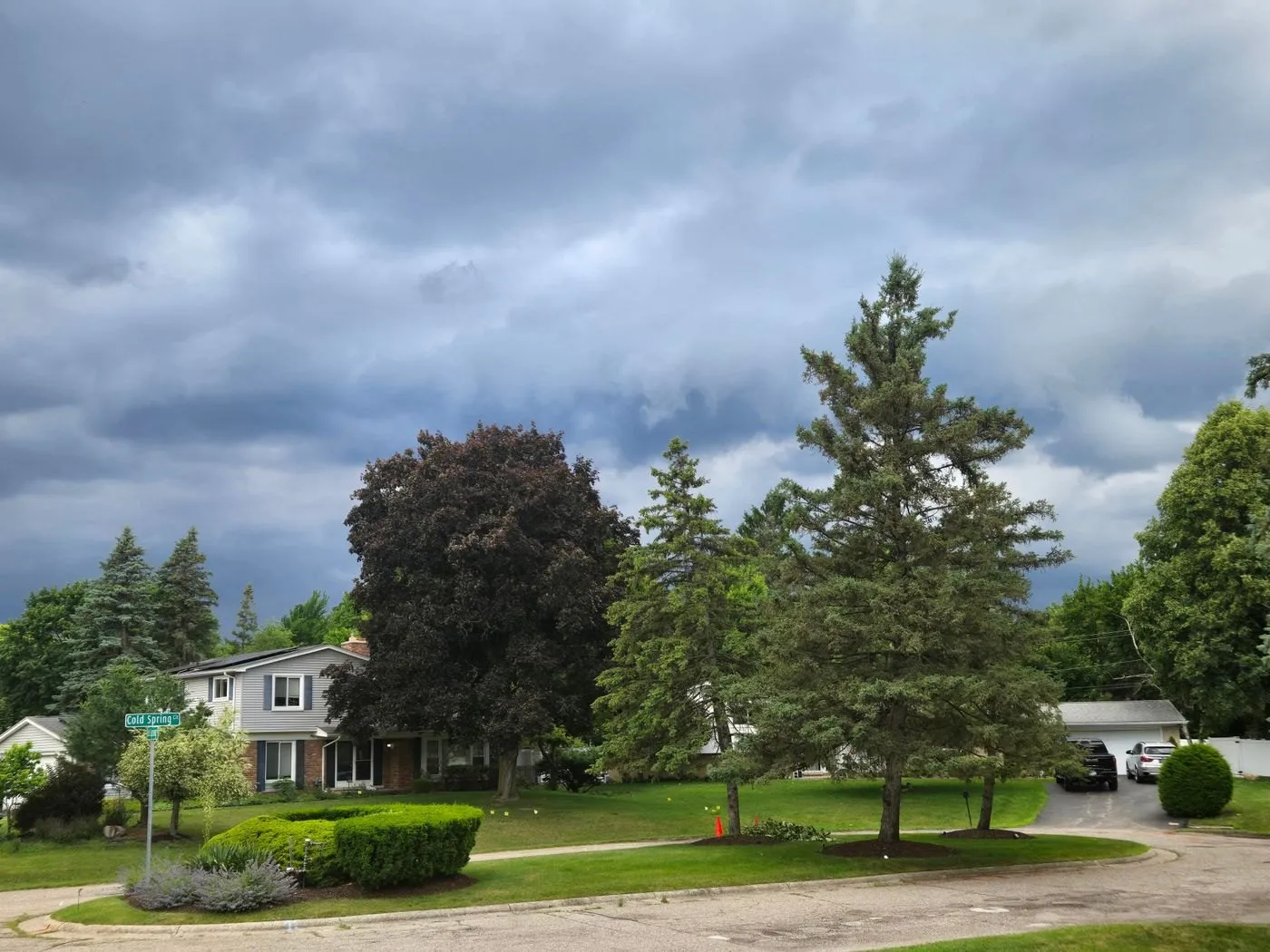 Dark storm clouds gathering over a Michigan suburban neighborhood